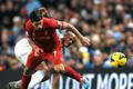 Liverpool's Suarez challenges Manchester City's Kompany during their English Premier League soccer match in Manchester