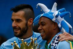 Manchester City's Alvaro Negredo and team mate Fernandinho celebrate after winning the English Premier League trophy