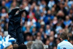 Manchester City's manager Manuel Pellegrini is thrown into the air by his team as they celebrate winning the English Premier League trophy following their soccer match against West Ham United