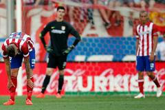 Atletico Madrid's Alderweireld, goalkeeper Courtois and Miranda react after conceding a goal against Malaga during their Spanish first division soccer match in Madrid