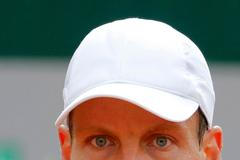 Tomas Berdych of the Czech Republic eyes the ball during his men's quarter final match against Ernests Gulbis of Latvia at the French Open Tennis tournament at the Roland Garros stadium in Paris