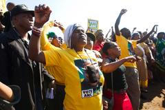 Supporters of African National Congress greet South African President Jacob Zuma after he voted at a voting station in the Nkandla district