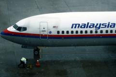A ground staff works near a Malaysia Airlines aircraft at the Kuala Lumpur International Airport in Sepang