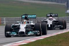 Mercedes Formula One driver Hamilton drives ahead of McLaren Formula One driver Button during the second practice session of the Malaysian F1 Grand Prix at Sepang International Circuit outside Kuala L