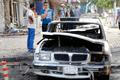 People gather at the site of a car bomb attack in Baghdad