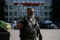 A pro-Russian rebel holds a knife as he stands near a local government building in downtown Kramatorsk