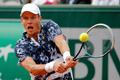 Tomas Berdych of the Czech Republic returns the ball to Ernests Gulbis of Latvia during their men's quarter final match at the French Open Tennis tournament at the Roland Garros stadium in Paris
