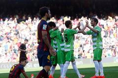 Getafe's players celebrate a goal against Barcelona's Cesc Fabregas during their La Liga soccer match at Camp Nou stadium in Barcelona