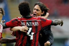 AC Milan's Muntari celebrates with his coach Inzaghi after scoring goal against Lazio  during their Italian Serie A match in Milan