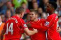 Liverpool's Moreno celebrates with teammates Henderson and Sturridge after scoring his team's third goal during their English Premier League soccer match against Tottenham Hotspur at White Hart Lane i