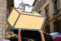 A Catalan pro-independence supporter holds a cut-out of a ballot box during a protest against the Spanish Constitutional Court in Barcelona