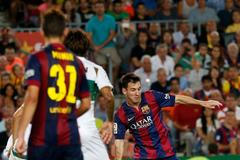 Barcelona's Lionel Messi scores his second goal  against Elche during their Spanish first division soccer match at Nou Camp stadium in Barcelona