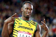 Bolt of Jamaica gestures before competing in a heat of the men's 4x100m relay at the 2014 Commonwealth Games in Glasgow