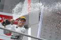 Mercedes Formula One driver Rosberg sprays champagne as he celebrates on podium after winningGerman F1 Grand Prix at Hockenheim