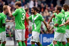 VfL Wolfburg's Ricardo Rodriguez celebrates with teammates after scoring against Bayer Leverkusen during the German Bundesliga first division soccer match in Wolfsbur