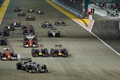 Mercedes Formula One driver Hamilton of leads the pack as team mate Rosberg starts from the pit lane following problems with his car during the Singapore F1 Grand Prix at the Marina Bay street circuit