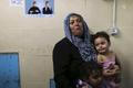 Relatives of Palestinians, whom hospital officials said were wounded by Israeli air strike, cry at hospital in Gaza City