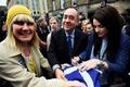 Scotland's First Minister Alex Salmond and local singer-songwriter Amy Macdonald  sign a 'Yes' supporter's flag during an event in Edinburgh, Scotland