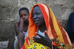 A woman talks about her escape from violence after Boko Haram insurgents attacked their community weeks ago, at the IDP camp at Wurojuli