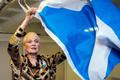 Designer Vivienne Westwood poses with a Scottish flag backstage before the presentation of her Vivienne Westwood Red Label Spring/Summer 2015 collection during London Fashion Week