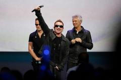 Bono of Irish rock band U2 gestures to the audience after performing at an Apple event at the Flint Center in Cupertino