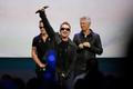 Bono of Irish rock band U2 gestures to the audience after performing at an Apple event at the Flint Center in Cupertino