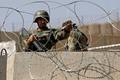 Afghan National Army soldier keeps watch at gate of a British-run military training academy Camp Qargha, in Kabul