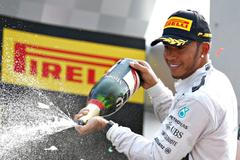 Mercedes Formula One driver Hamilton of Britain celebrates with champagne after winning the Italian F1 Grand Prix in Monza
