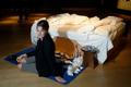 Artist Emin poses with her conceptual artwork "My Bed" at Christie's auction house in London