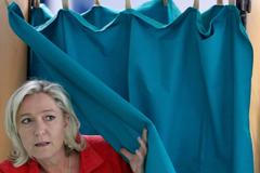 Marine Le Pen, France's National Front political party head, leaves the polling booth before casting her ballot in the European Parliament election in Henin-Beaumont