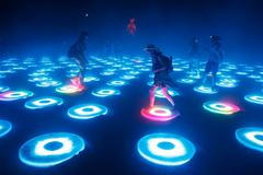 Participants interact with the art installation The Super Pool during a dust storm at the Burning Man 2014 "Caravansary" arts and music festival in the Black Rock Desert of Nevada