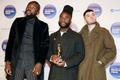 Young Fathers pose with their trophy after winning the 2014 Mercury Prize in London