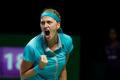 Petra Kvitova of the Czech Republic celebrates a point against Maria Sharapova of Russia during their WTA Finals singles tennis match at the Singapore Indoor Stadium