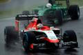 Marussia Formula One driver Bianchi of France drives in front of Caterham Formula One driver Kobayashi of Japan during the Japanese F1 Grand Prix at the Suzuka Circuit