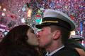 A couple kisses amid confetti as the clock strikes midnight during New Year's Eve celebrations in Times Square, New York