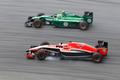 Marussia Formula One driver Bianchi passes Caterham Formula One driver Ericsson during the first practice session of the Malaysian F1 Grand Prix at Sepang International Circuit outside Kuala Lumpur