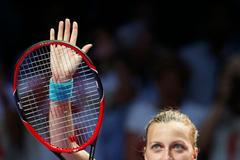 Petra Kvitova of the Czech Republic acknowledges the audience after defeating Maria Sharapova of Russia during their WTA Finals singles tennis match at the Singapore Indoor Stadium
