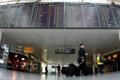 Pilots pass flight schedule board announcing cancelled flights by German air carrier Lufthansa at Munich's airport