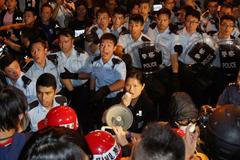 Police react as they are about to disperse pro-democracy protesters off a vehicle tunnel near the government headquarters in Hong Kong