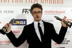 Pawlikowski poses with his trophies for European director and screenwriter for his work in the movie "Ida" after the European Film Awards ceremony in Riga