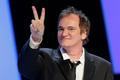 US director Quentin Tarantino flashes a victory sign as he arrives on the stage during the 39th Cesar Awards ceremony in Paris