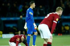 Sparta Prague players stand dejected after BSC Young Boys scored a second goal during Europa League match in Bern