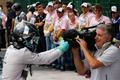 Mercedes Formula One driver Nico Rosberg of Germany jokes with the cameraman to celebrate as he steps out of his car after winning the Brazilian Grand Prix in Sao Paulo