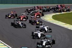 Mercedes Formula One driver Nico Rosberg of Germany leads the first curve ahead of teammate Lewis Hamilton of Britain during the Brazilian Grand Prix in Sao Paulo