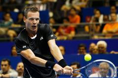 Singapore Slammers' Tomas Berdych of the Czech Republic hits a return to Manila Mavericks' Jo-Wilfried Tsonga of France during their men's singles match at the International Premier Tennis League (IPT