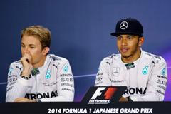 Mercedes Formula One driver Lewis Hamilton of Britain and teammate Nico Rosberg of Germany attend a news conference after the Japanese F1 Grand Prix at the Suzuka Circuit