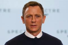 Actor Daniel Craig poses on stage during an event to mark the start of production for the new James Bond film "Spectre" at Pinewood Studios
