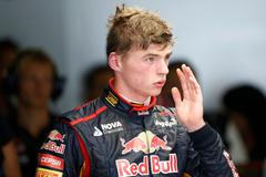 Toro Rosso Formula One driver Verstappen of the Netherlands returns to the garage after his car stalled on the track during the first practice session of the Japanese F1 Grand Prix at the Suzuka Circu