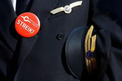 Lufthansa pilot wears badge reading "strike" on his uniform as he takes part in a demonstration at Fraport airport in Frankfurt