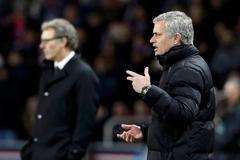 Chelsea's coach Mourinho reacts near Paris St Germain's coach Blanc during their Champions League round of 16 first leg soccer match at the Parc des Princes Stadium in Paris